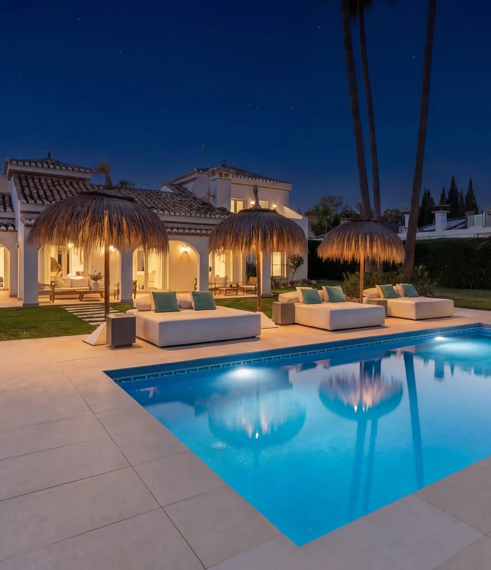 Luxury villa with pool and lit terraces at dusk, Marbella