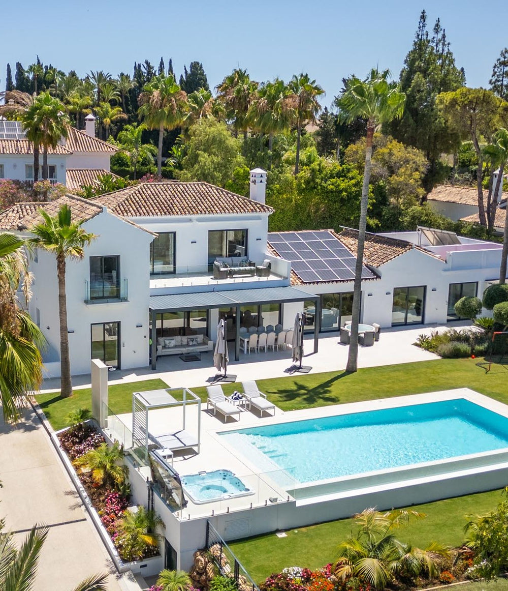 Aerial view of a family villa with pool and garden in Guadalmina Baja, Marbella