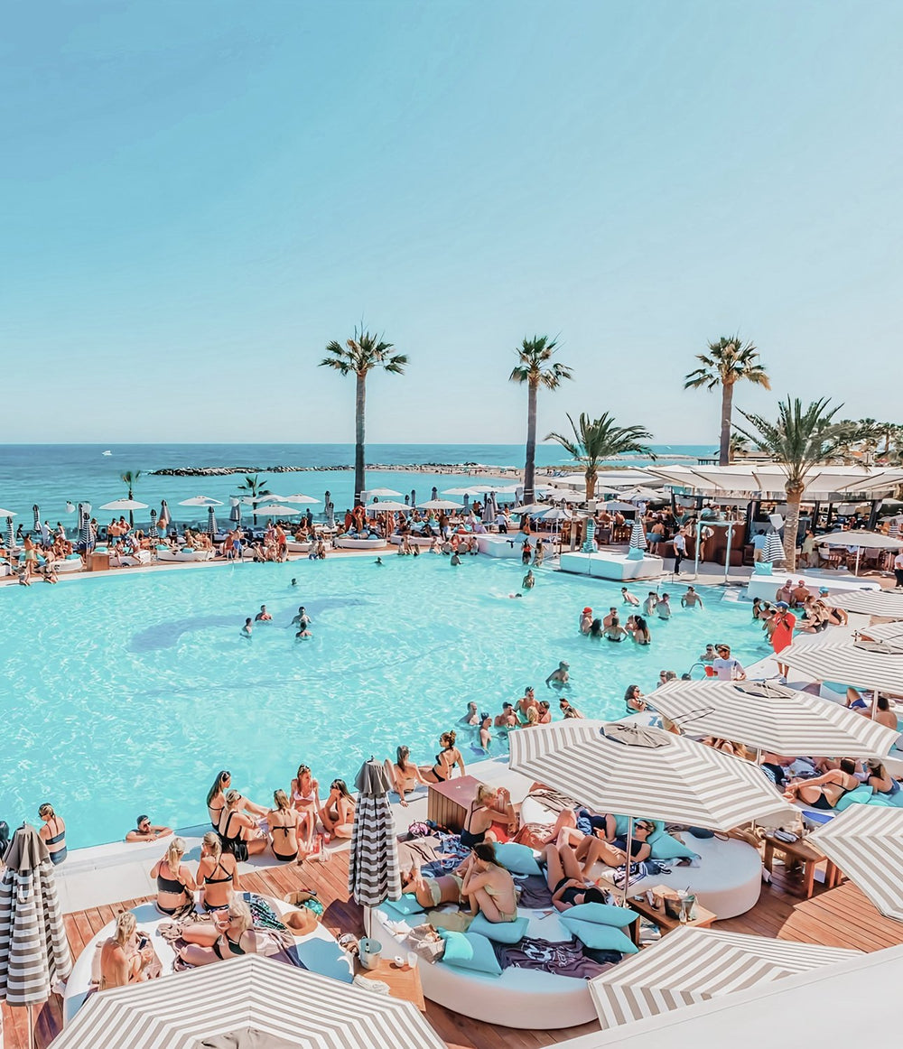 Guests around the large saltwater pool at Ocean Club, Puerto Banús, Marbella