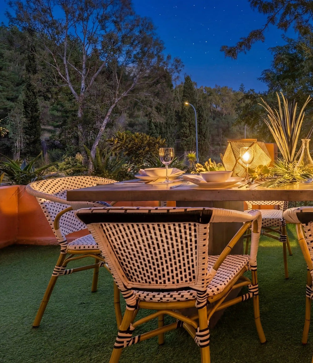 Dinner table set for guests on a villa terrace at dusk, Marbella
