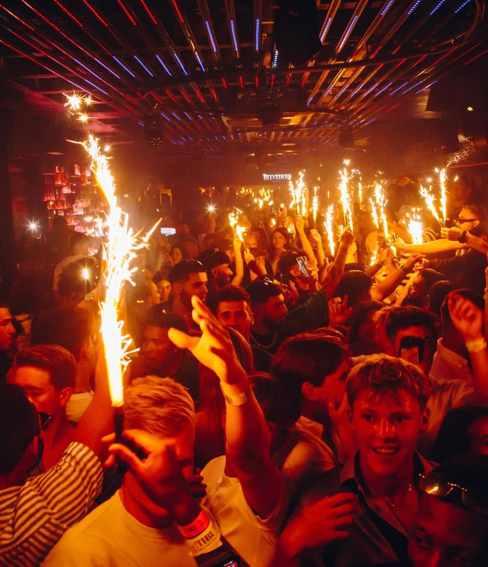 Party crowd with sparklers on the dance floor at Tibu, Puerto Banús