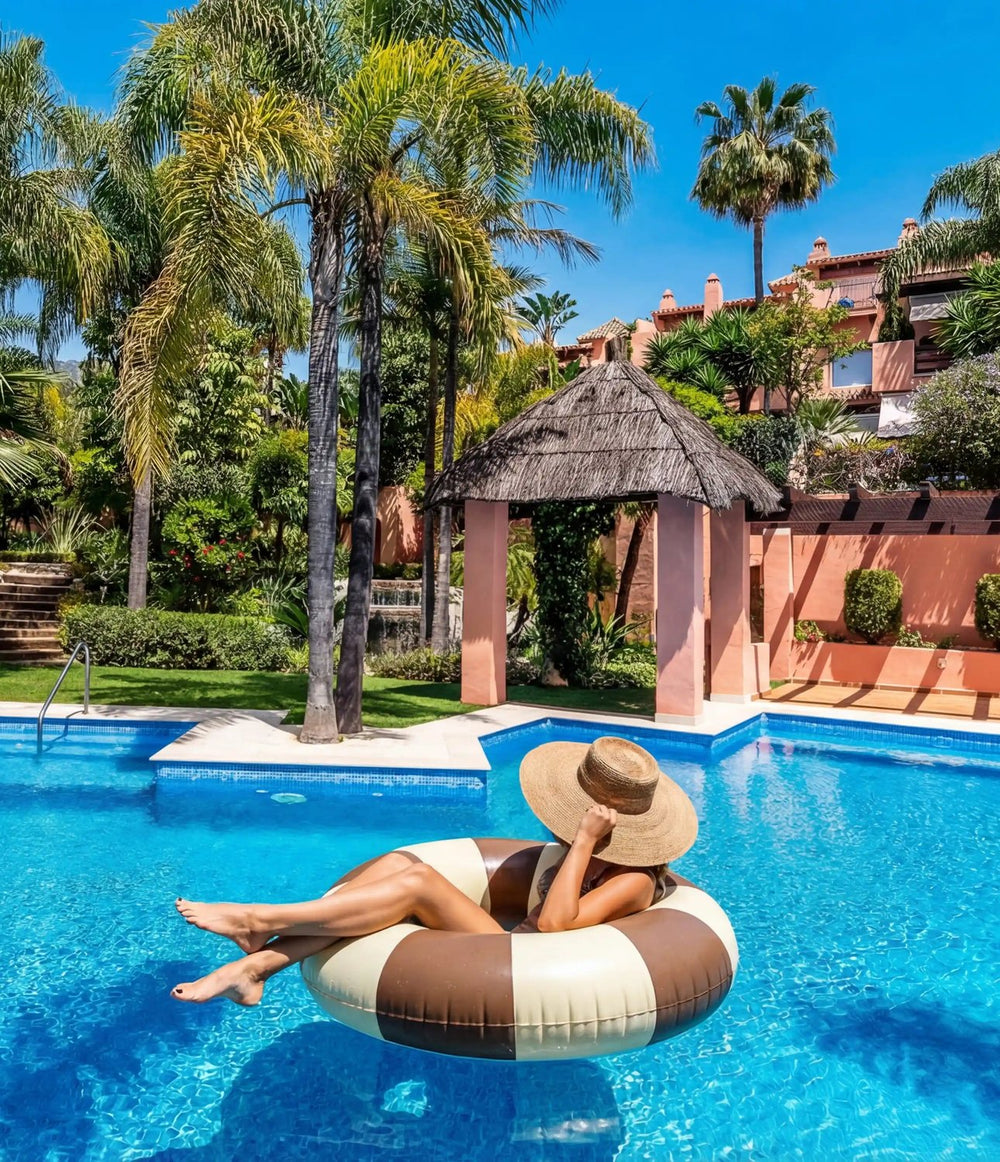 Guest floating on a ring in the pool of a rental villa, Marbella