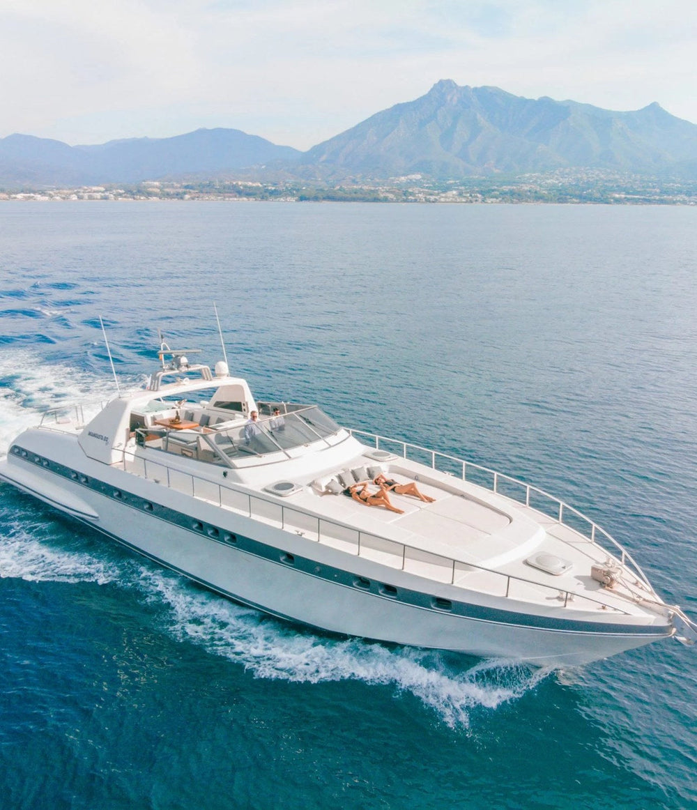 Mangusta 80 motor yacht cruising off Marbella with La Concha mountain behind