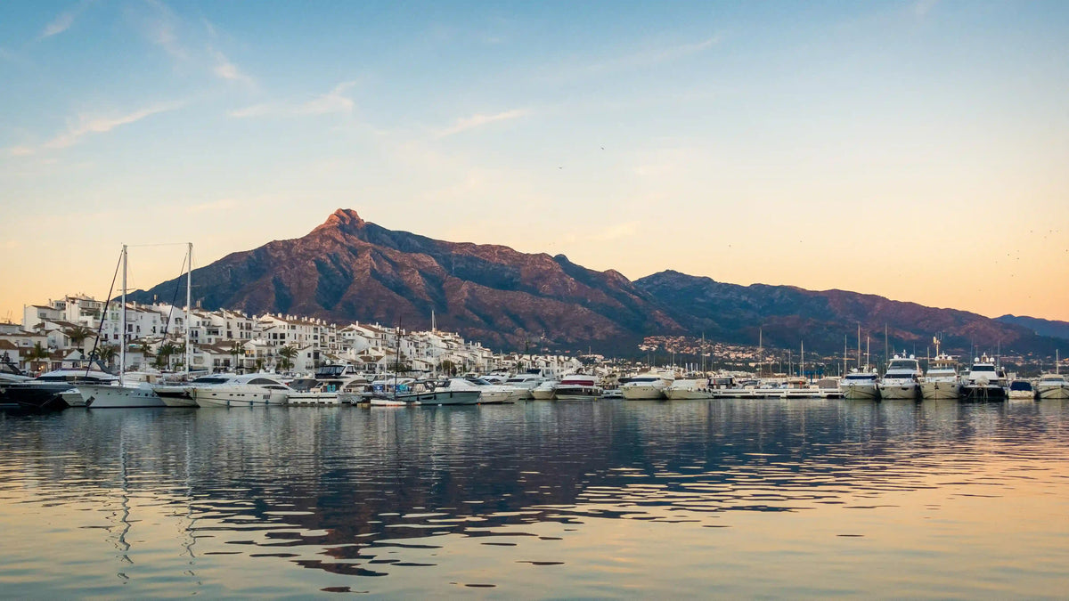 Puerto Banús marina at dusk with yachts and La Concha mountain, Marbella
